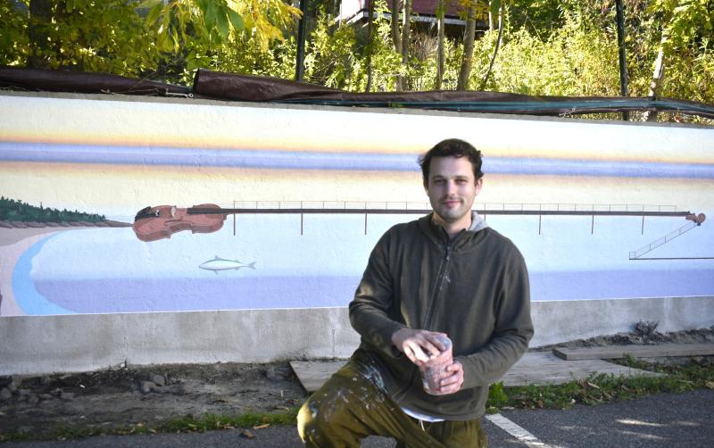 Artist Dan Nielsen set against his mural design in progress on the back wall of the Opera House parking lot. LISA KRISTOFF/Boothbay Register