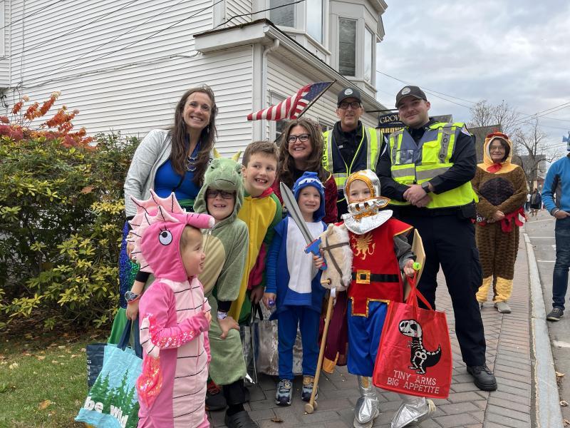 A group stops for a photo with Boothbay Harbor police officers near Grover's Hardware during the 2025 parade. Bethany Schmidt photo