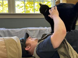 Eric Hutchinson helping to socialize a cat at MidCoast Humane Society, Volunteer