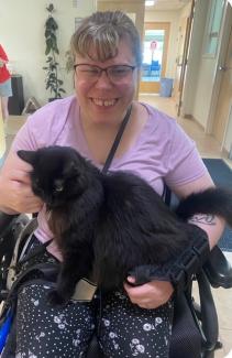 Savannah Robinson helping with a cat at Pope Memorial Humane Society girl and cat