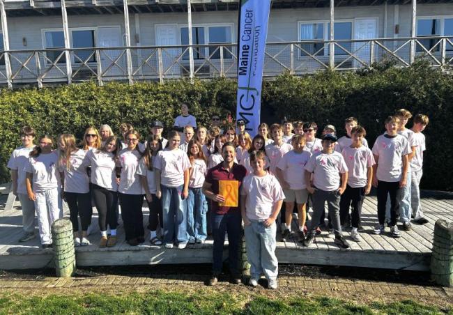 Boothbay Region Elementary School eighth graders and teachers present $1,500 to Maine Cancer Foundation Executive Director Ray Ruby in the Whale Park Oct. 30. KEVIN BURNHAM/Boothbay Register