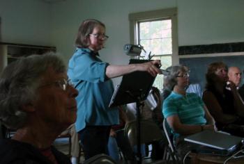 Doreen Conboy of Alna changes a slide in her July 27 talk on the life of Joe Jones, a local scow captain in the late 1800s and early 1900s. SUSAN JOHNS/Wiscasset Newspaper