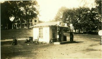Colby's Filling Station, at the corner of Townsend Avenue and Union Street, in 1936. The present Thistle Inn on Oak Street is up the hill on the left. Courtesy of Kenny Poole. Below, Peanut Lewis' Calso Gas Station in 1953, with the Opera House on the left and Oak Street above.