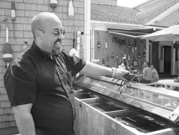 Manager of the Senator Inn Roger Bintliff cooks up lobsters at Fisherman's Wharf on July 20. HILARY RIBONS/Boothbay Register