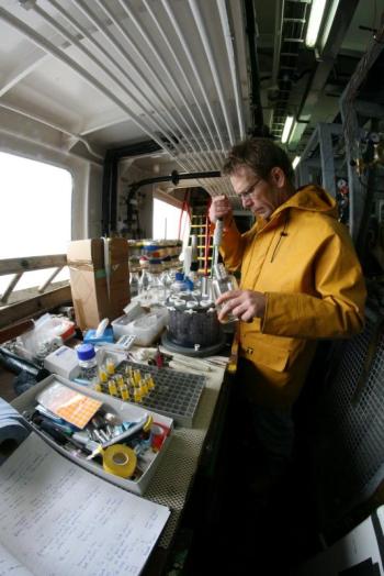 Dr. Steve Archer processes water samples on the Discovery, North Atlantic, summer 2011. Courtesy of Seb Hennige