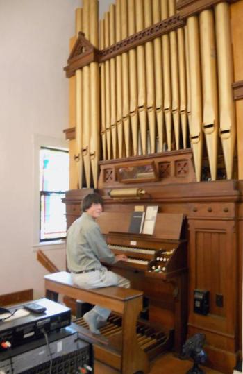 Mitch Boucher practices at the organ for his performance for the Champagne of the Sheepscot. Courtesy of Sheepscot Valley Conservation Association