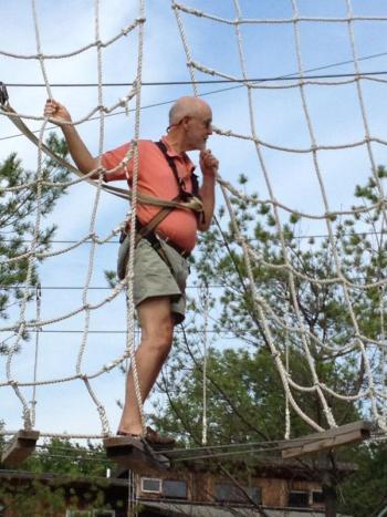 Edgecomb summer resident Don Fry gears up for his zipline descent.