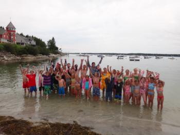 Participants in the Arthur Hale Veasey Memorial Regatta pose, victoriously exuberant, at the close of competition in Spring Cove at Squirrel Island on August 21. The regatta has been held in memory of its founder, Arthur Hale Veasey, at the island each summer since its inception over 70 years ago.