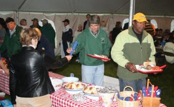 Robin Cole, right, former linebacker for the Pittsburgh Steelers, at the lobster bake last year. Cole is one of the many sports celebrities returning to the Boothbay Charities Classic September 21 and 22 to raise money for Special Olympics Maine. JOHN EDWARDS/Boothbay Register