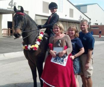 Boothbay's Hali Goodwin after her win on CBMF Off The Charts. Also pictured are, from front, trainer Katie Yereance and Goodwin's parents, Amy and Dusty Goodwin. Courtesy of Amy Goodwin
