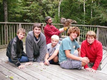 Troop 238 visited Birdsacre Sanctuary in Ellsworth. Pictured from left are, front: Parker Elkins; Jacob Bishopp; Draco Peaslee; Sherman Brewer; Jake Brewer; back: birdhandler Grayson with a resident owl. Below, Jacob Bishopp learns how to hold a wood duck on his birthday. Courtesy of Sarah Sherman Troop 238 visited Birdsacre Sanctuary in Ellsworth. Pictured from left are, front: Parker Elkins; Jacob Bishopp; Draco Peaslee; Sherman Brewer; Jake Brewer; back: birdhandler Grayson with a resident owl. Courtesy of Sarah Sherman