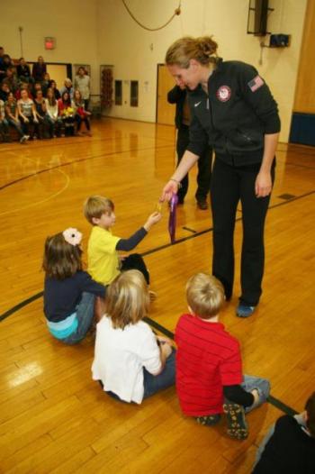 Ellie Logan shows students one of her two Olympic gold medals. KEVIN BURNHAM/Boothbay Register