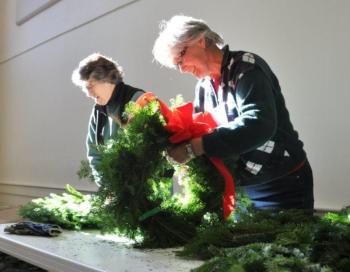 Valerie Betts works at the wreath table November 14 during a Boothbay Region Garden Club event at the Southport Town Hall. Below: Jane Lunt, left, and Penny Thumith work together to construct cocoa cones, and De Amplo constructs a gingerbread house. BEN BULKELEY/Boothbay Register Valerie Betts works at the wreath table November 14 during a Boothbay Region Garden Club event at the Southport Town Hall. BEN BULKELEY/Boothbay Register