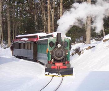 The train chugs through the snow toward Santa’s Station. Courtesy of the Boothbay Railway Village 