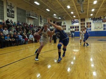 Captain Alex Clarke drives hard to the basket, trying to outrun her Madison defender.  RYAN LEIGHTON/ Boothbay Register 