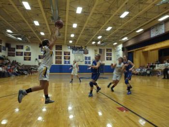 Abby McLellan grabs a high flying pass as Sarah Caron cuts down the middle.  RYAN LEIGHTON/ Boothbay Register 