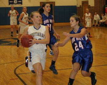 Morgan Crocker drives to the basket against Oak Hill's Danielle Samson. KEVIN BURNHAM/Boothbay Register