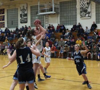 Alex Clarke dodges the Dirigo defense with a spin-around shot in the lane.
