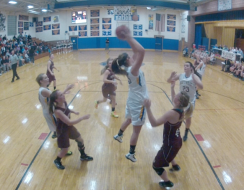 Alex Clarke grabs a rebound over Monmouth during the home opener, December 11. RYAN LEIGHTON/Boothbay Register