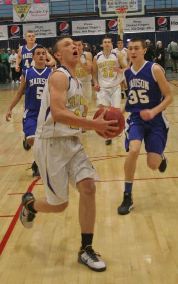 Andrew Hallinan drives to the basket on a fast break for two of his 13 points. KEVIN BURNHAM/Boothbay Register