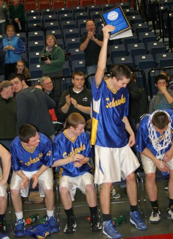 Sophomore John Hepburn holds up the Harry Edwards award after being named the outstanding player of the tournament. KEVIN BURNHAM/Boothbay Register 