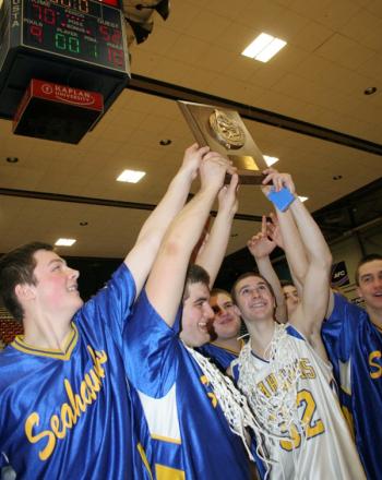 Team captains Linc Simmons and Anthony DiMauro hold up the championship plaque while surrounded by teammates. KEVIN BURNHAM/Boothbay Register