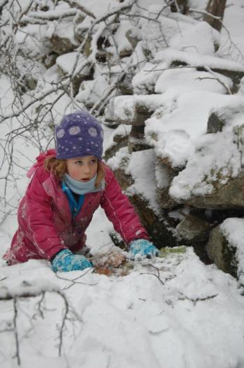 Audrey Hufnagel a first grader at the Juniper Hill School takes part in an outdoor lesson on winter animals and tracking. The Alna-based school will host an open house on March 14, at 3 p.m. Courtesy of Juniper Hill School