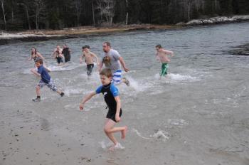 Swimmers race back onto shore following a short dip into the ocean off Hendrick's Head Beach on Southport. BEN BULKELEY/Boothbay Register