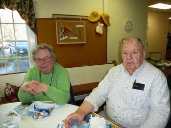 Bawn Clifton, left, and Bill Koutzmann relax after enjoying slices of Pastor Sarah Foulger’s blueberry pie. KATRINA CLARK/Boothbay Register