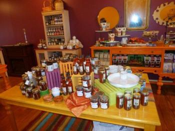 A wide range of jams, hot sauce, relish and serving dishes await eager customers. Behind the table is a sideboard showing a range of new chocolates featuring Eventide’s oils and balsamics. Below: Owner Denise Demeter holds a Food Slab board, one of the many new products being sold at Eventide Artisan Bread & Cheese. KATRINA CLARK/Boothbay Register A wide range of jams, hot sauce, relish and serving dishes await eager customers. Behind the table is a sideboard showing a range of new chocolates featuring Eventide’s oils and balsamics. KATRINA CLARK/Boothbay Register