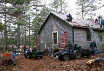 Spring 2005: Almost 50 years to the day from when construction first commenced, club volunteers gather to install a much needed new roof on their club house. Courtesy of Lucy Schmidt Spring 2005: Almost 50 years to the day from when construction first commenced, club volunteers gather to install a much needed new roof on their club house. Courtesy of Lucy Schmidt