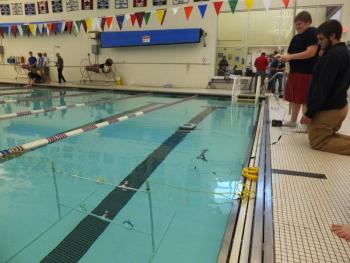Eli Farnham maneuvers his robot at the YMCA pool in Bath, while his partner Linc Simmons looks on. Below: Dan Murray poses with his Seaperch robot. Murray and his partner Alex Owen placed second in the contest. RYAN LEIGHTON/Boothbay Register Eli Farnham maneuvers his robot at the YMCA pool in Bath, while his partner Linc Simmons looks on. RYAN LEIGHTON/Boothbay Register