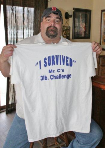 Chef Chris Gistis holds the T-shirt that every one of the entrants in the May 4 eating contest will receive. KEVIN BURNHAM/Boothbay Register