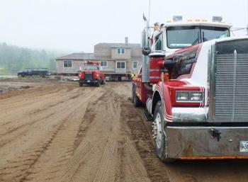 Two wrecker trucks trucks get ready to haul the country club house up to the hill on May 29. RYAN LEIGHTON/Boothbay Register Two wrecker trucks trucks get ready to haul the country club house up to the hill on May 29. RYAN LEIGHTON/Boothbay Register