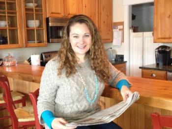 Abby Gordon at her Boothbay Harbor condo, catching up on local news in the Boothbay Register. LISA KRISTOFF/Boothbay Register