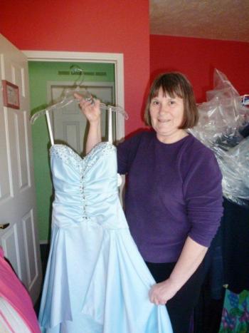 Cheryl Lorrain shows off one of the many free dresses available for local girls to wear to prom. KATRINA CLARK/Boothbay Register