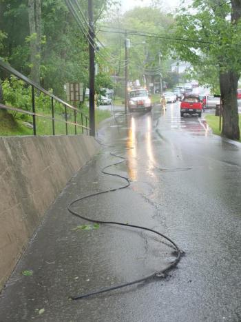 Downed power lines on Oak Street stop traffic, as a Central Maine Power truck arrives at the scene. RYAN LEIGHTON/Boothbay Register