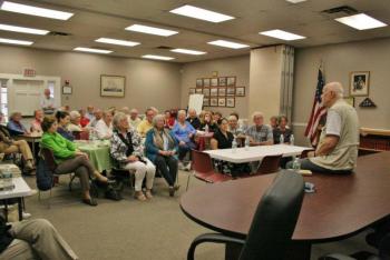 Perkins touts his new book, “Finding Moosewood, Finding God,” on June 14 at the Boothbay Harbor Town Hall. Program Director Barb House said the event had to be moved from the library to a bigger venue to accommodate those interested in attending the event. NICOLE LYONS/Boothbay Register Perkins touts his new book, “Finding Moosewood, Finding God,” on June 14 at the Boothbay Harbor Town Hall. Program Director Barb House said the event had to be moved from the library to a bigger venue to accommodate those interested in attending the event. NICOLE LYONS/Boothbay Register