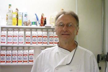 John Reed stands by “his” spice rack in the Fisherman’s Wharf kitchen where he creates the sauces on the menu. KATRINA CLARK/Boothbay Register