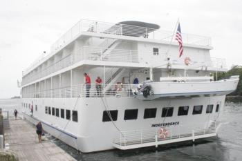 "Independence," an American Cruise Lines ship and frequent visitor to Boothbay Harbor, is tied off by Wotton Wharf’s dock master, Chuck Chaney and Boothbay Region Boatyard’s dock master Amy Armstrong in this September 2012 photo. Independence begins its weekly visits to the harbor this week. LISA KRISTOFF/Boothbay Register