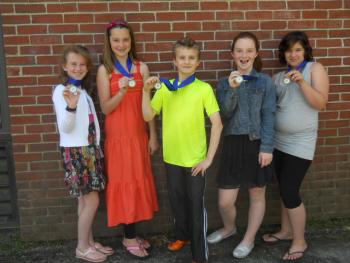Gold medal winners from left, Ellie Hilscher, Hali Goodwin, Rowan Kristan, Josie Smith and Ciara Pitcher show off their ribbons from the state's Maine in Motion program. Photos courtesy of Rita Arnold