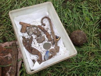 A small sample of the artifacts dug up from the ground in Pemaquid. Among other things, pictured are a musket flint, a lice comb, a coin, a fish spear and a swivel gun cannon ball to the right. BEN BULKELEY/Boothbay Register A small sample of the artifacts dug up from the ground in Pemaquid. Among other things, pictured are a musket flint, a lice comb, a coin, a fish spear and a swivel gun cannon ball to the right. BEN BULKELEY/Boothbay Register
