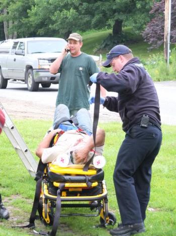 Herb Reno, 46, of Bath is loaded into a gurney after falling off a 25 foot roof. RYAN LEIGHTON/Boothbay Register