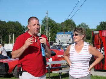Wiscasset Speedway announcer and promoter Ken Minott, left, and track co-owner Vanessa Jordan address the crowd at a dedication of “Wilford's,” a concession stand named in honor of Wilford Cronk. Cronk  built the track in the 1960s. He died earlier this year. SUSAN JOHNS/Wiscasset Newspaper