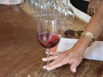 The hand of Kathy Pomian of Orwisburg, Pennsylvania, swooshes some wine before Pomian tastes it at Treat's. SUSAN JOHNS/The Wiscasset Newspaper