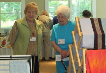 Ursula Smith, left, talks about her woven works at the Vendor's Market. LISA KRISTOFF/Boothbay Register Ursula Smith, left, talks about her woven works at the Vendor's Market. LISA KRISTOFF/Boothbay Register