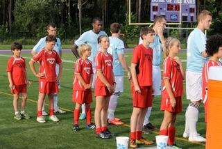 Midcoast United players escort Portland Phoenix onto the pitch at their July 6 match again the Western Massachusetts Pioneers. Midcoast United players from the left: Maddox Tillas, Simon Spear, Jack Duncan, Ella Spear, Timmy Chappelle, Malaika Pasch, and Bayly Gaughan.