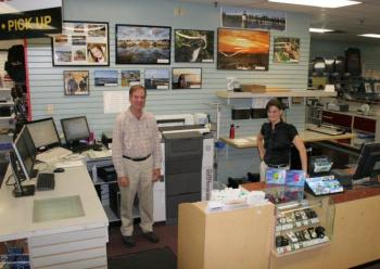 Conall O’Brien, left, and Leisha MacDougall stand in the photo processing area at Video Loft. The new, all-digital photo processing equipment speeds up delivery and photographs are sharper than when the business used chemicals to print photographs. KEVIN BURNHAM/Boothbay Register Conall O’Brien, left, and Leisha MacDougall stand in the photo processing area at Video Loft. The new, all-digital photo processing equipment speeds up delivery and photographs are sharper than when the business used chemicals to print photographs. KEVIN BURNHAM/Boothbay Register