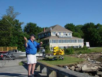 Forrest Faulkingham demonstrates a fishing technique at the Recreational Pier in Wiscasset. Below: Faulkingham’s clients have the use of equipment like this colorful fishing fly. SUSAN JOHNS/Wiscasset Newspaper Forrest Faulkingham demonstrates a fishing technique at the Recreational Pier in Wiscasset. SUSAN JOHNS/Wiscasset Newspaper