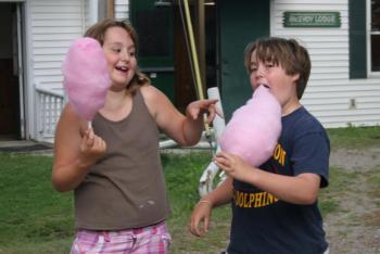 A young girl and boy enjoy some cotton candy at the Camp K Carnival. KEVIN BURNHAM/Boothbay Register